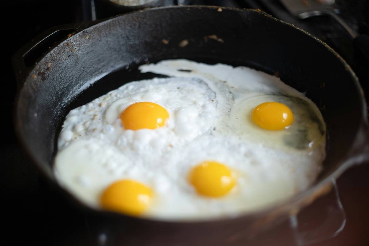 joie egg poacher instructions showing eggs steaming in stainless steel cups